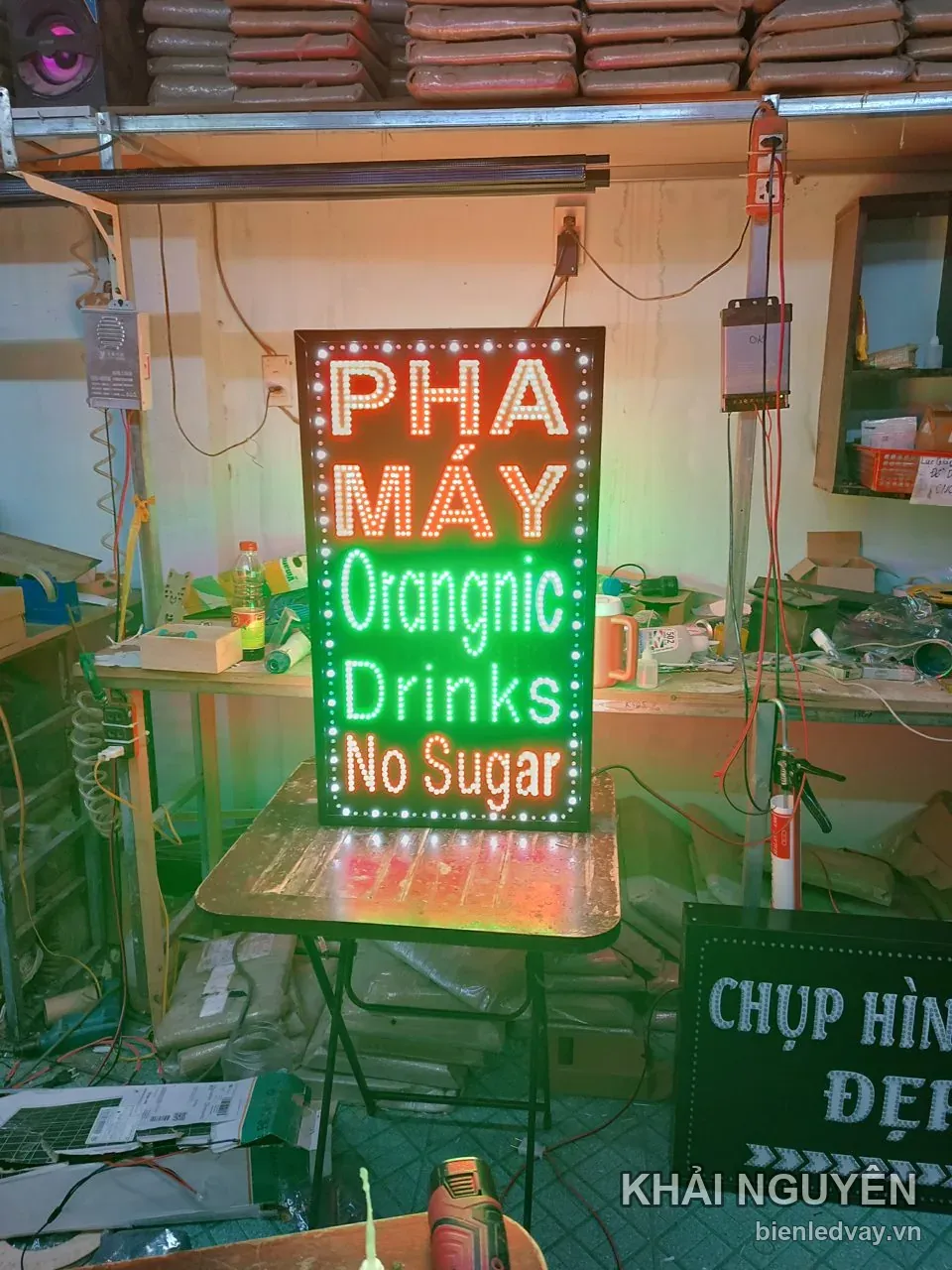 Biển vẫy LED dáng đứng, chữ PHA MÁY đỏ trắng, Orangnic Drinks màu xanh lá, No Sugar cam, viền bóng tròn trắng.