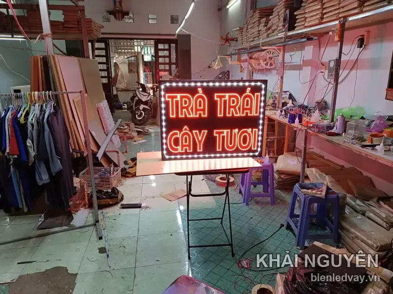 Biển LED chữ TRÀ TRÁI CÂY TƯƠI màu đỏ, viền bóng trắng, đặt trên chân xếp tại xưởng